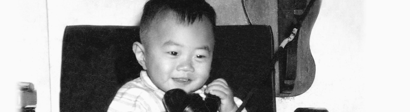 Young Bo Ling talking on an antique rotary phone